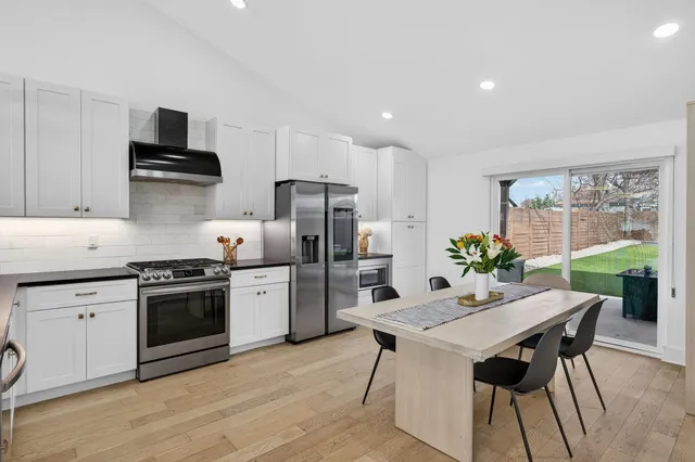 a kitchen with a stove a sink and a refrigerator