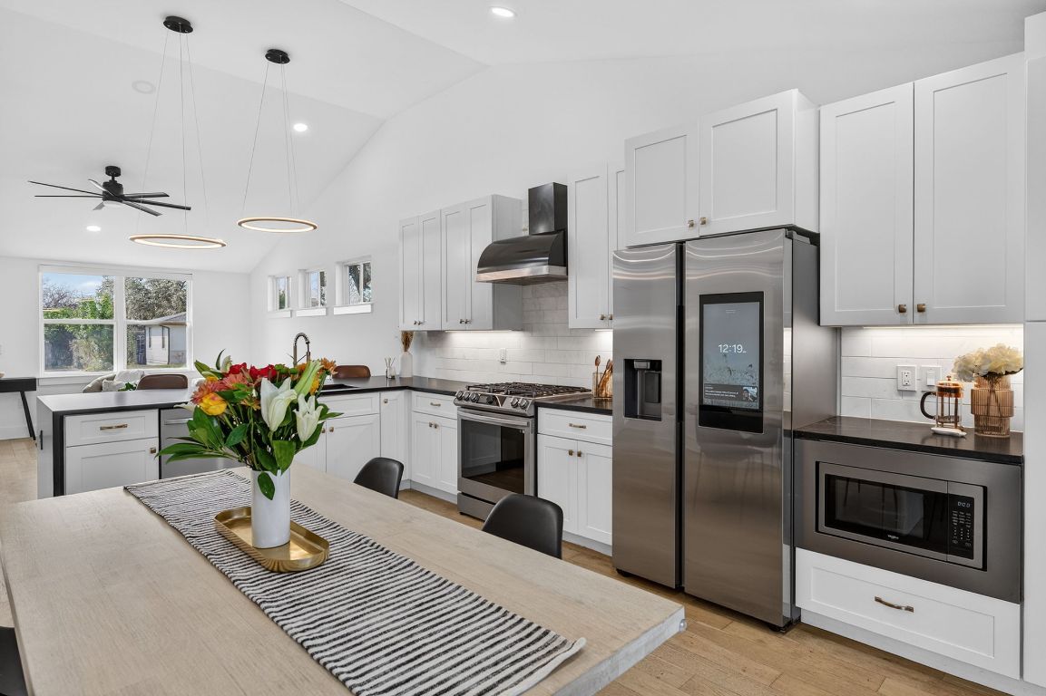 504 West Croslin Street Austin, TX 78752 - Photo 6 of 22 a kitchen with a refrigerator and a stove
