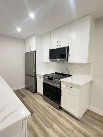 a kitchen with a refrigerator stove and microwave