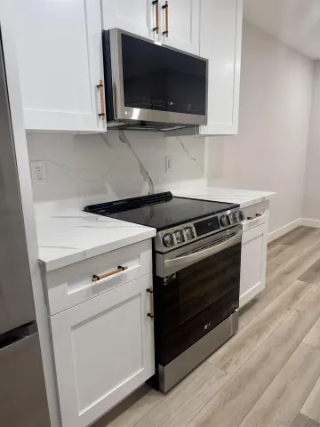 a kitchen with a stove and a microwave