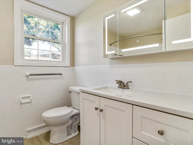 an empty room with a ceiling fan and a window