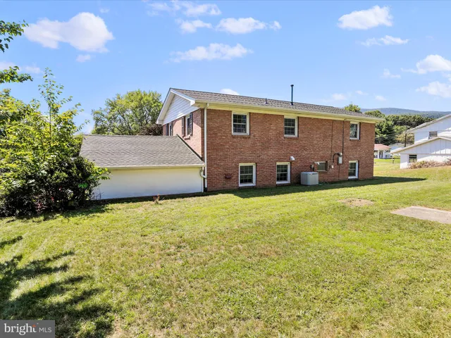 a front view of house with yard and trees