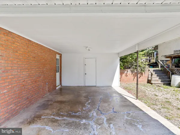 a front view of house with yard and trees in the background