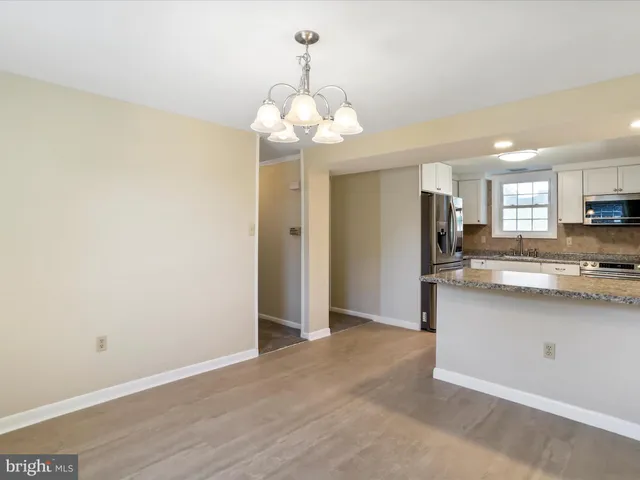 a kitchen with stainless steel appliances granite countertop a stove microwave and refrigerator