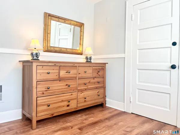 a view of a dresser with mirror in it