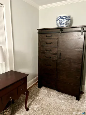 a bedroom with a bed and a mirror