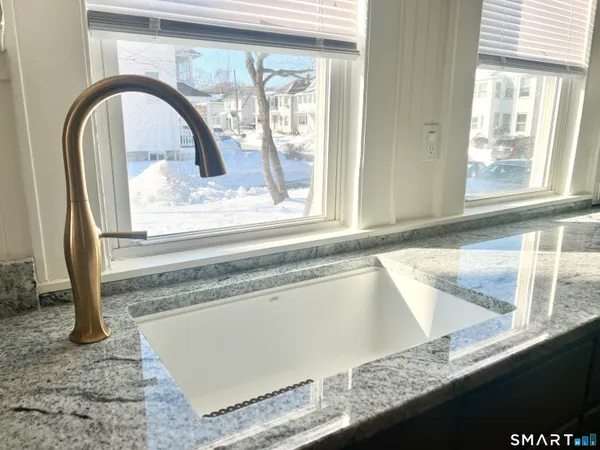 a view of a kitchen sink and a window