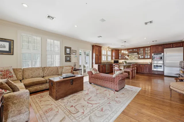 a spacious bedroom with a bed a couch and a large window