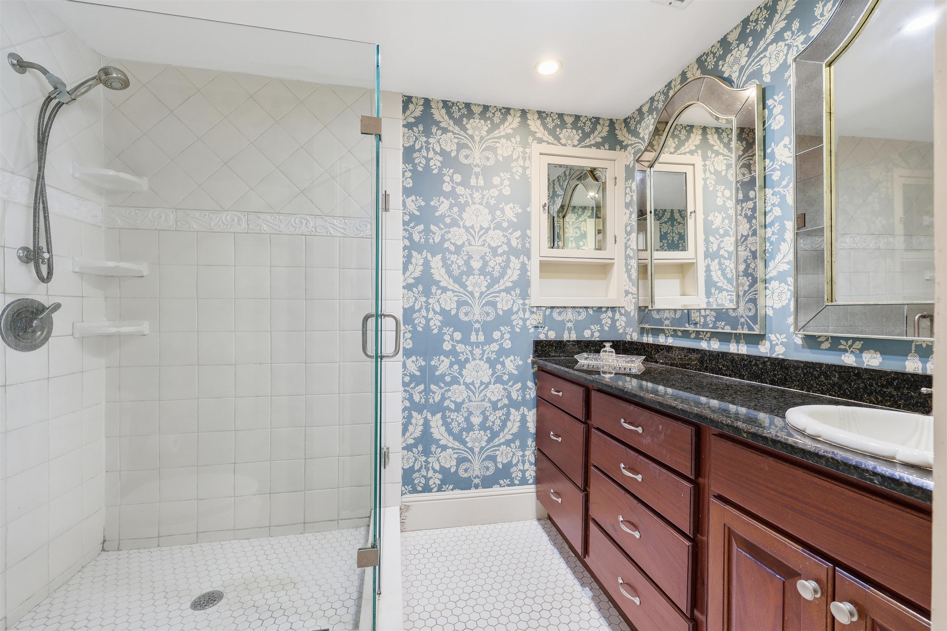 124 Marine Street St. Augustine, FL 32084 - Photo 22 of 41 a bathroom with a granite countertop sink a shower and a mirror