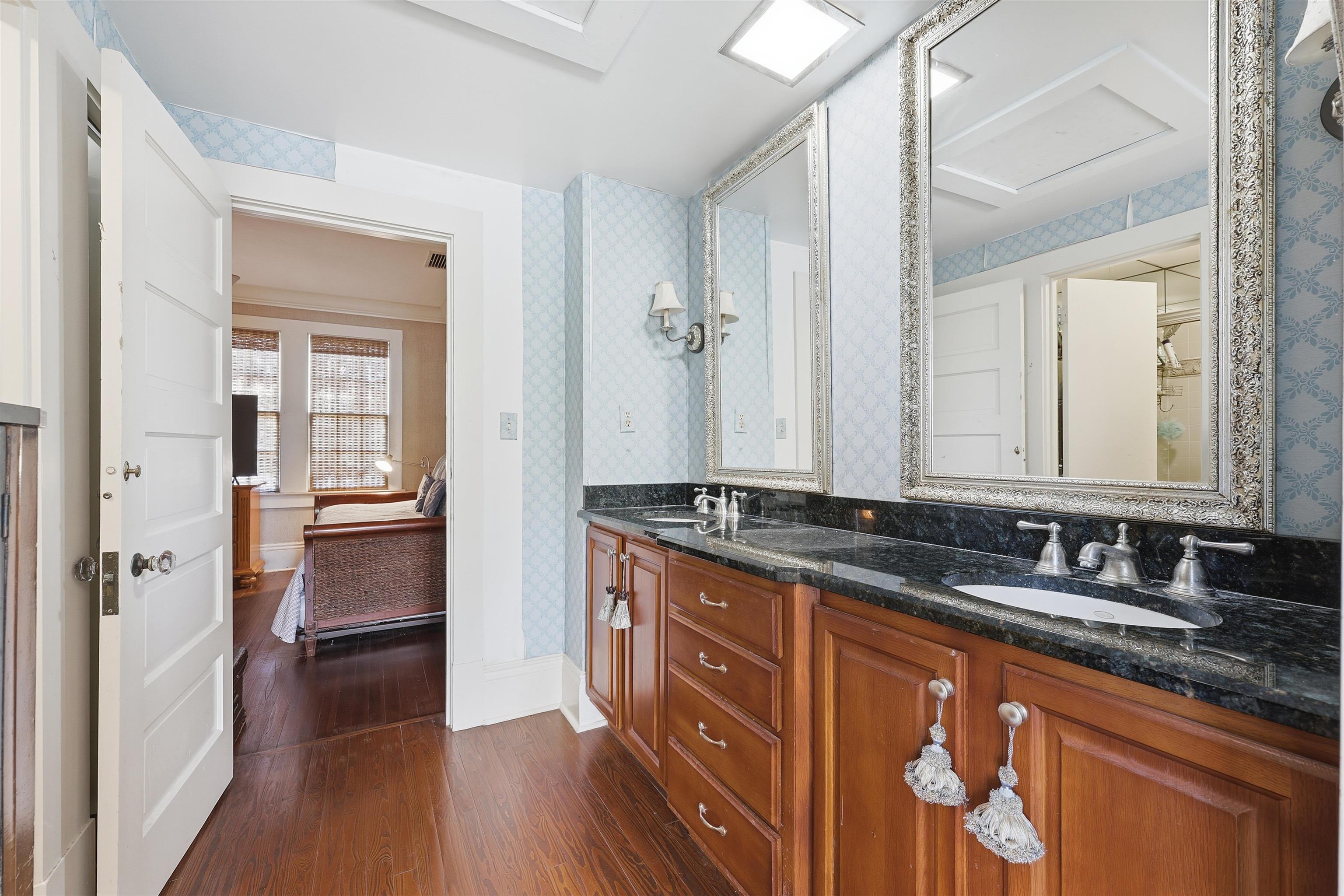 124 Marine Street St. Augustine, FL 32084 - Photo 24 of 41 a bathroom with granite countertop a sink and a large mirror