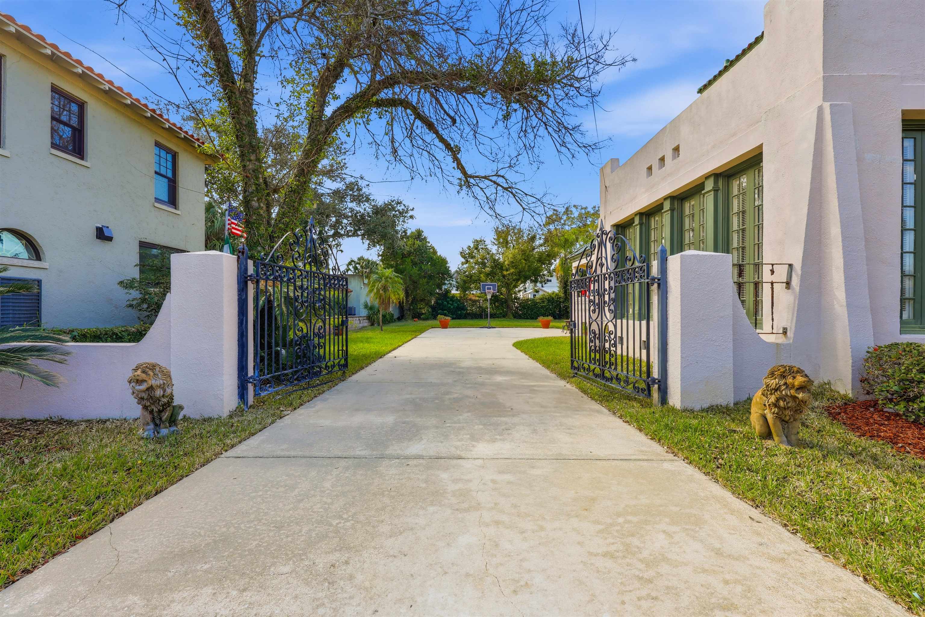 124 Marine Street St. Augustine, FL 32084 - Photo 29 of 41 a view of a backyard with potted plants and a large tree