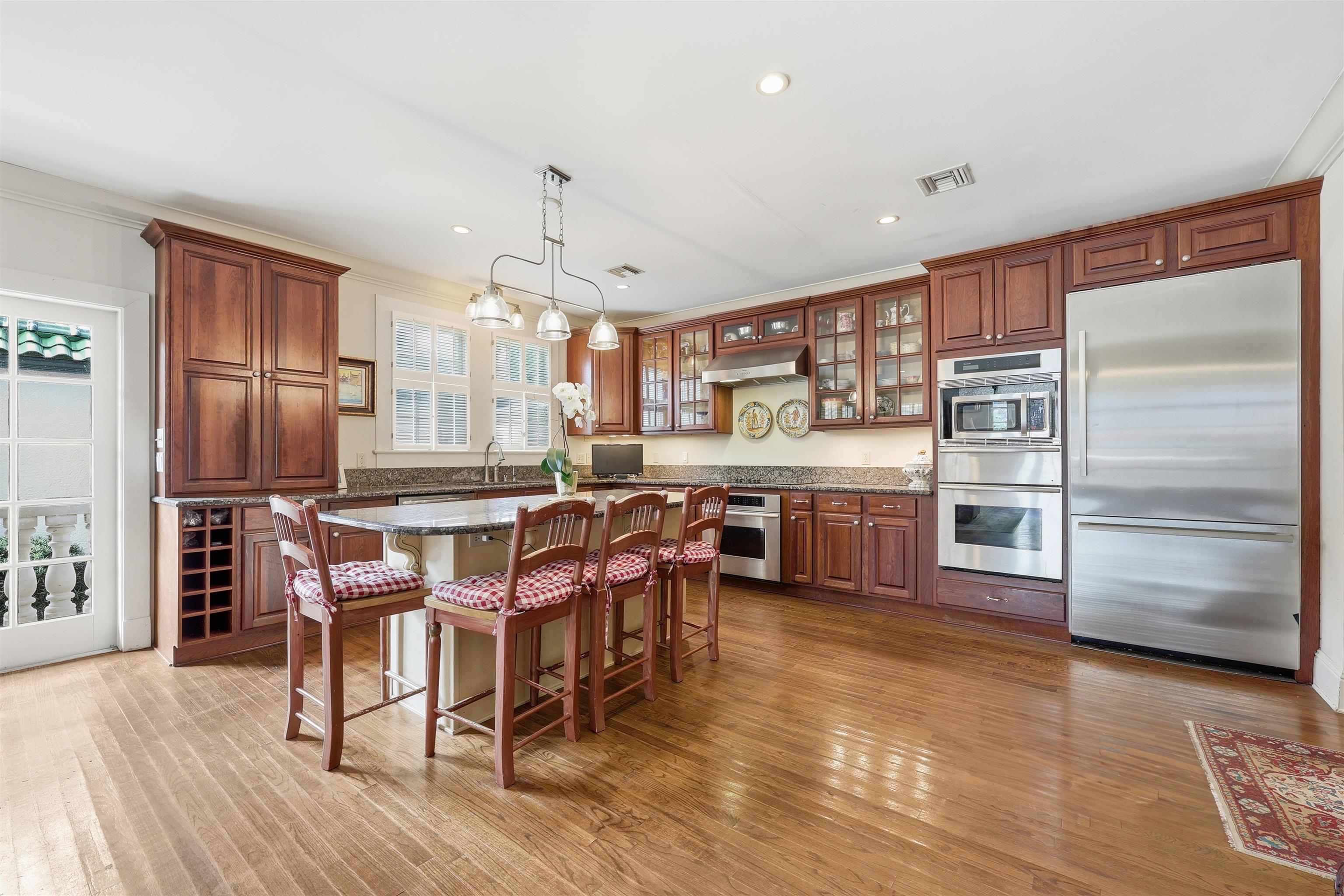 124 Marine Street St. Augustine, FL 32084 - Photo 2 of 41 a kitchen with stainless steel appliances a stove a sink dishwasher a oven a dining table and chairs with wooden floor
