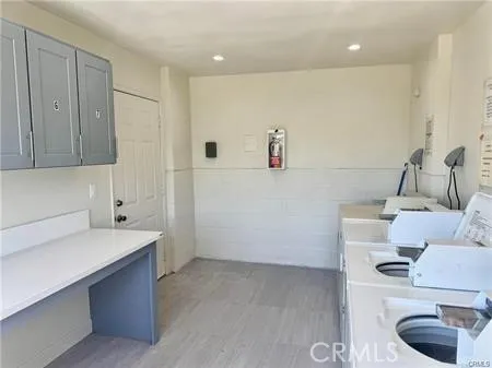a view of storage and utility room with two washing machine