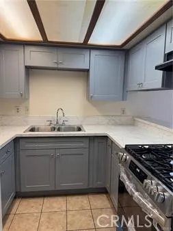 a kitchen with a sink a stove and cabinets