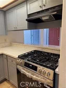 a stove top oven sitting inside of a kitchen