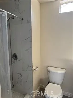 a bathroom with a toilet and a shower