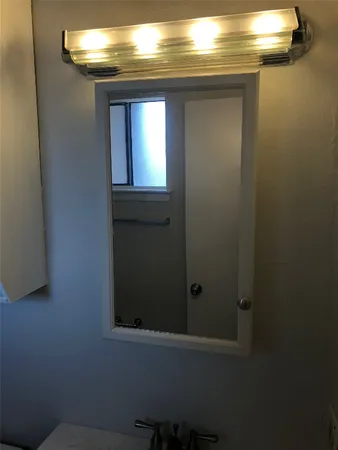 a bathroom with a light fixture and a sink