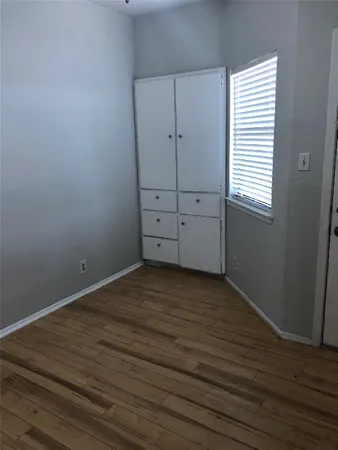 an empty room with wooden floor