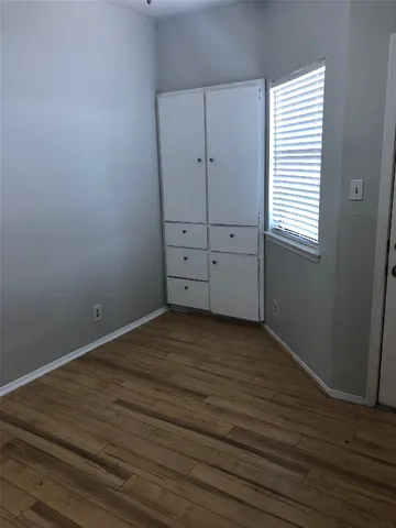 an empty room with wooden floor
