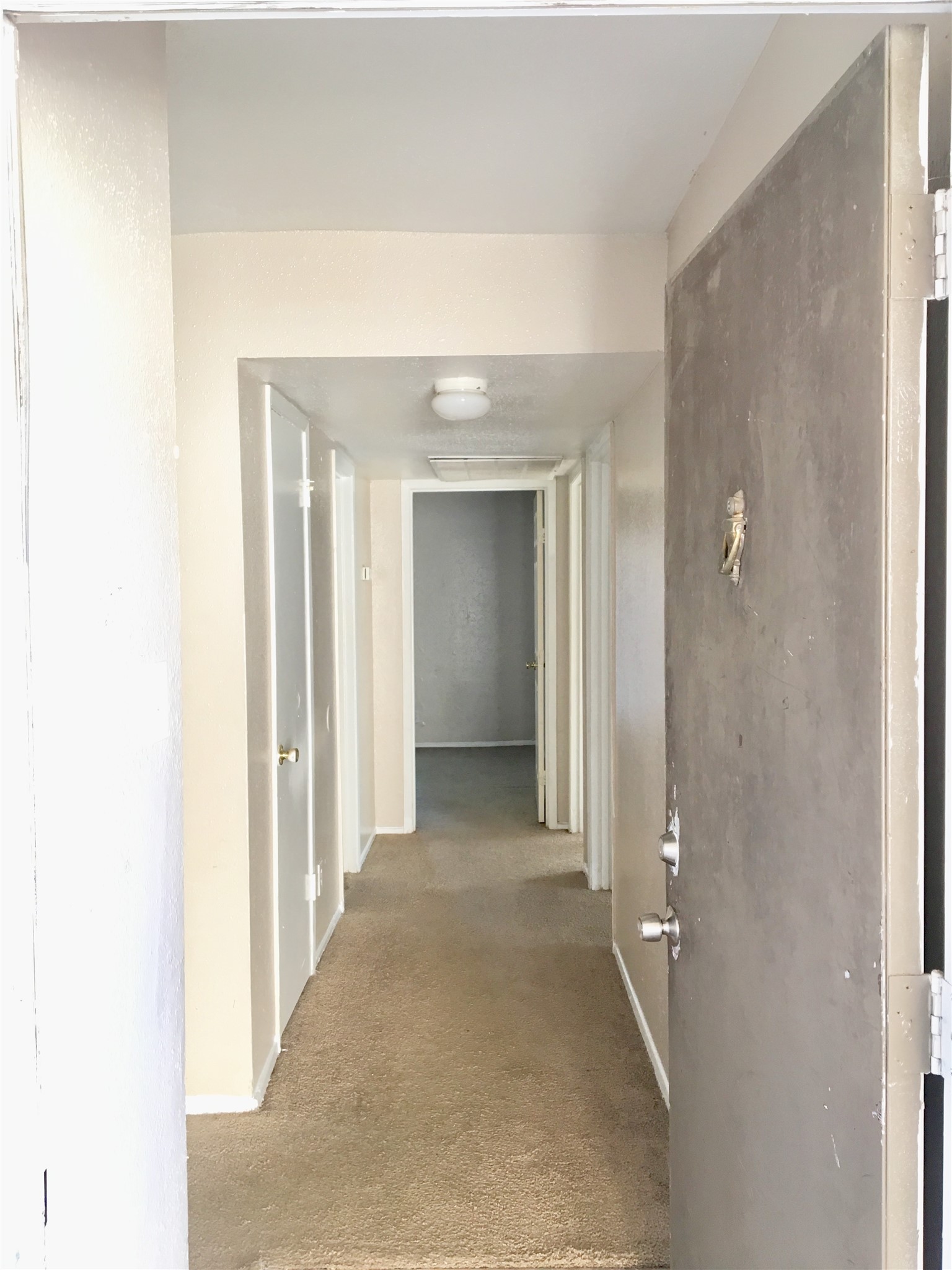 6200 West Tidwell Road, Unit 602 Houston, TX 77092 - Photo 7 of 9 a view of a hallway with wooden shelves