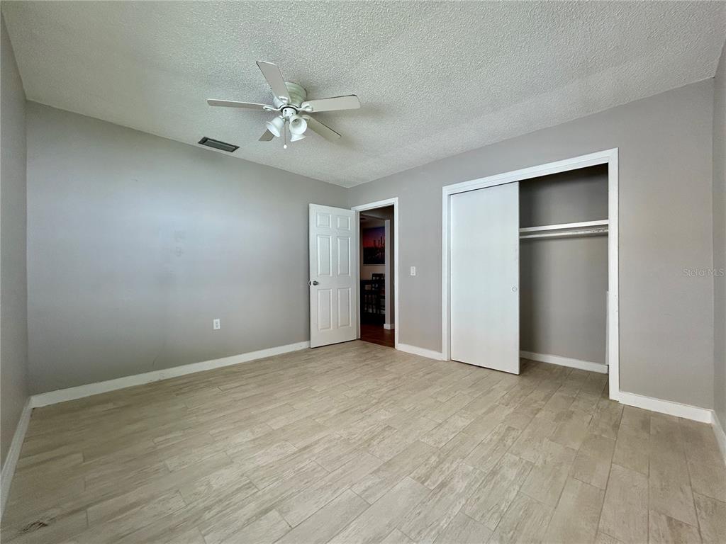 144 175th Avenue East, Unit 1 Redington Shores, FL 33708 - Photo 13 of 15 an empty room with closet and fan