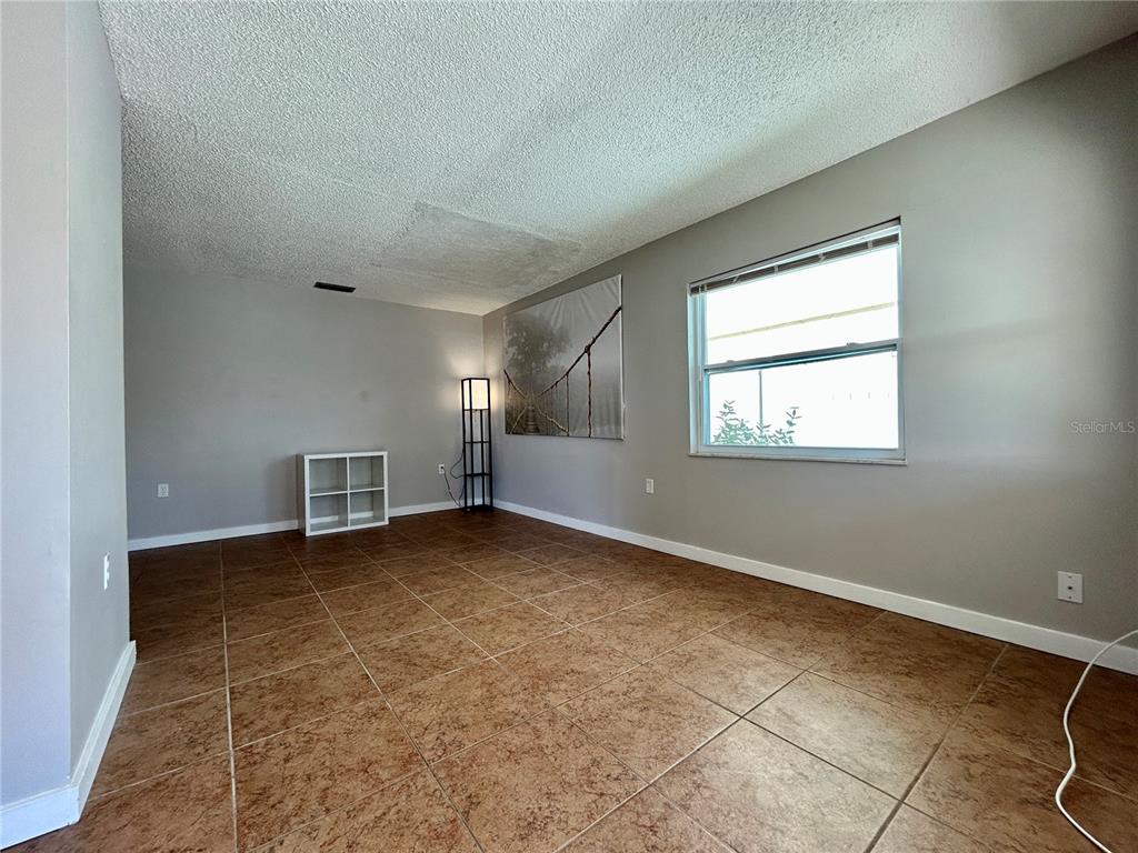 144 175th Avenue East, Unit 1 Redington Shores, FL 33708 - Photo 5 of 15 an empty room with windows