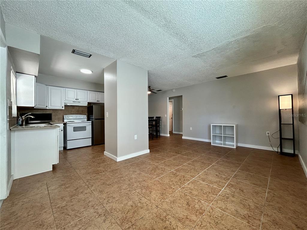 144 175th Avenue East, Unit 1 Redington Shores, FL 33708 - Photo 6 of 15 a view of a kitchen with a sink and a stove top oven