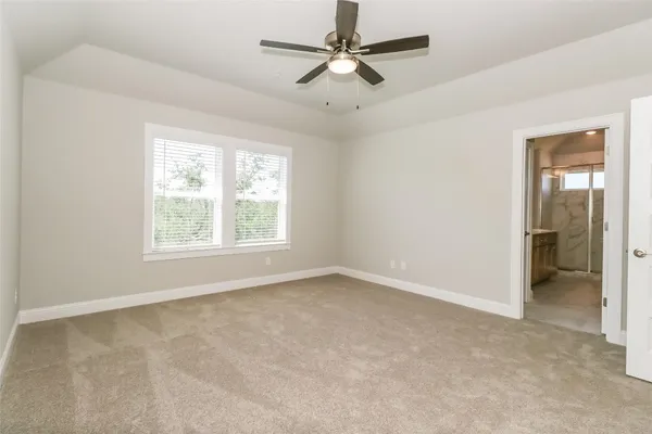 an empty room with closet and a chandelier fan