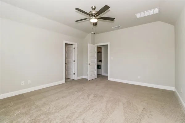 an empty room with a window and a fan