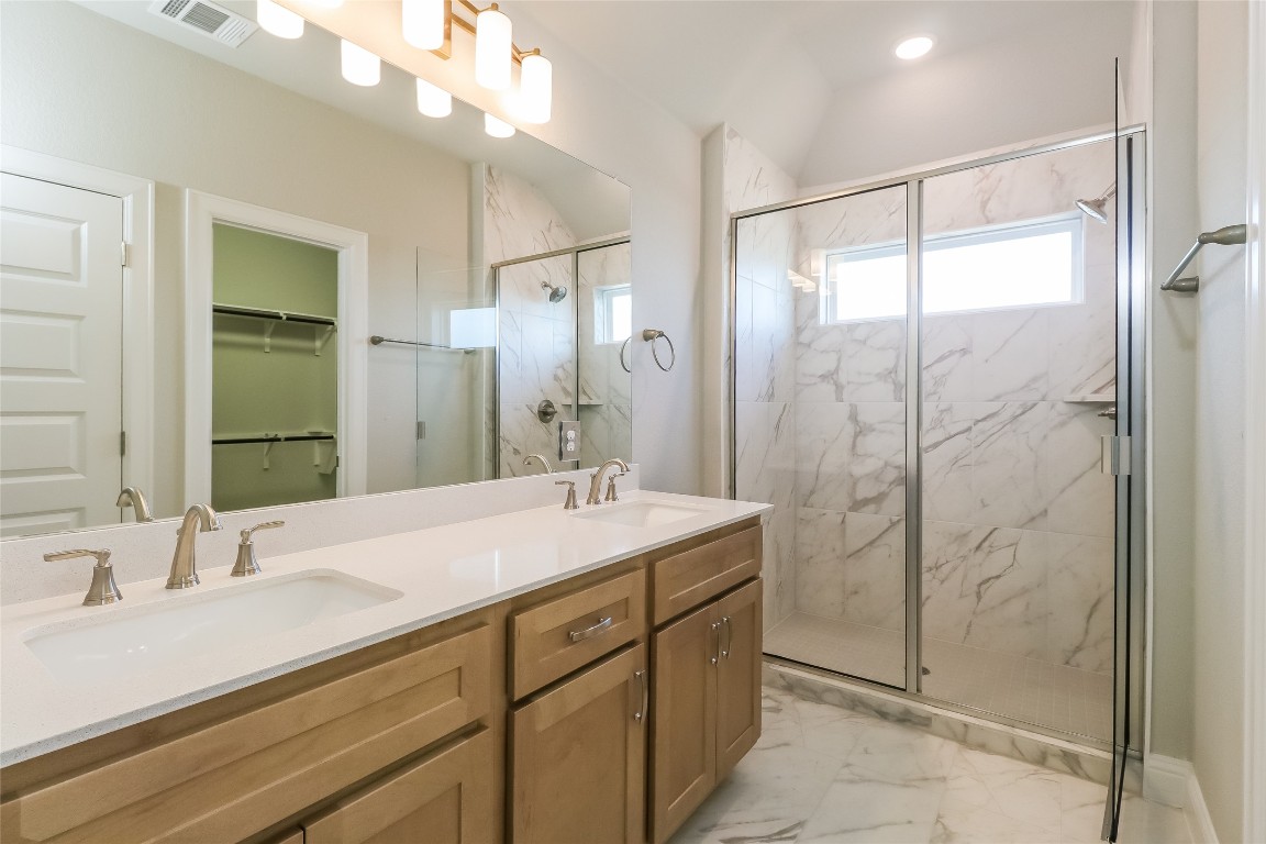 2605 Sam Bass Road, Unit 42 Round Rock, TX 78681 - Photo 13 of 27 a bathroom with a sink double vanity and shower