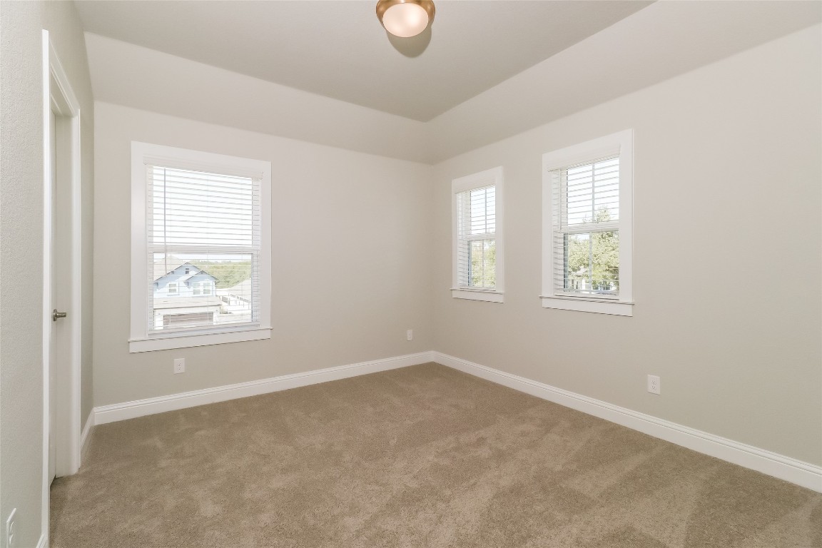 2605 Sam Bass Road, Unit 42 Round Rock, TX 78681 - Photo 17 of 27 an empty room with windows and mirror