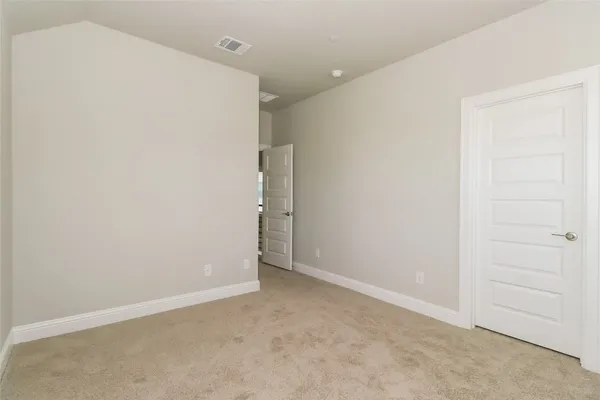 an empty room with windows and mirror