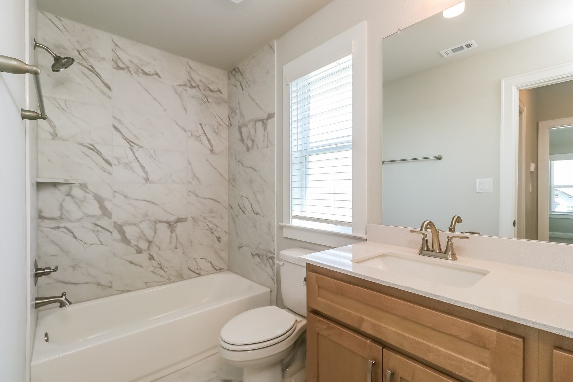 2605 Sam Bass Road, Unit 42 Round Rock, TX 78681 - Photo 21 of 27 a bathroom with a sink toilet a bathtub and shower