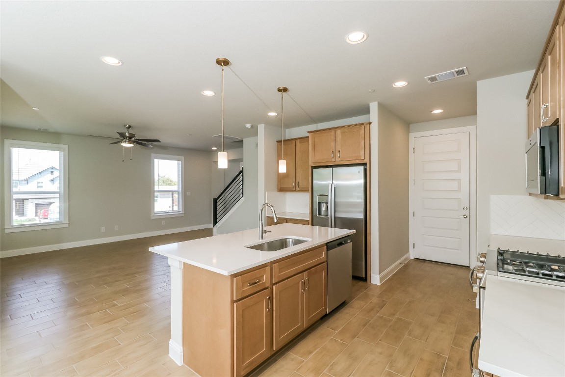 2605 Sam Bass Road, Unit 42 Round Rock, TX 78681 - Photo 26 of 27 a kitchen with a sink appliances and cabinets