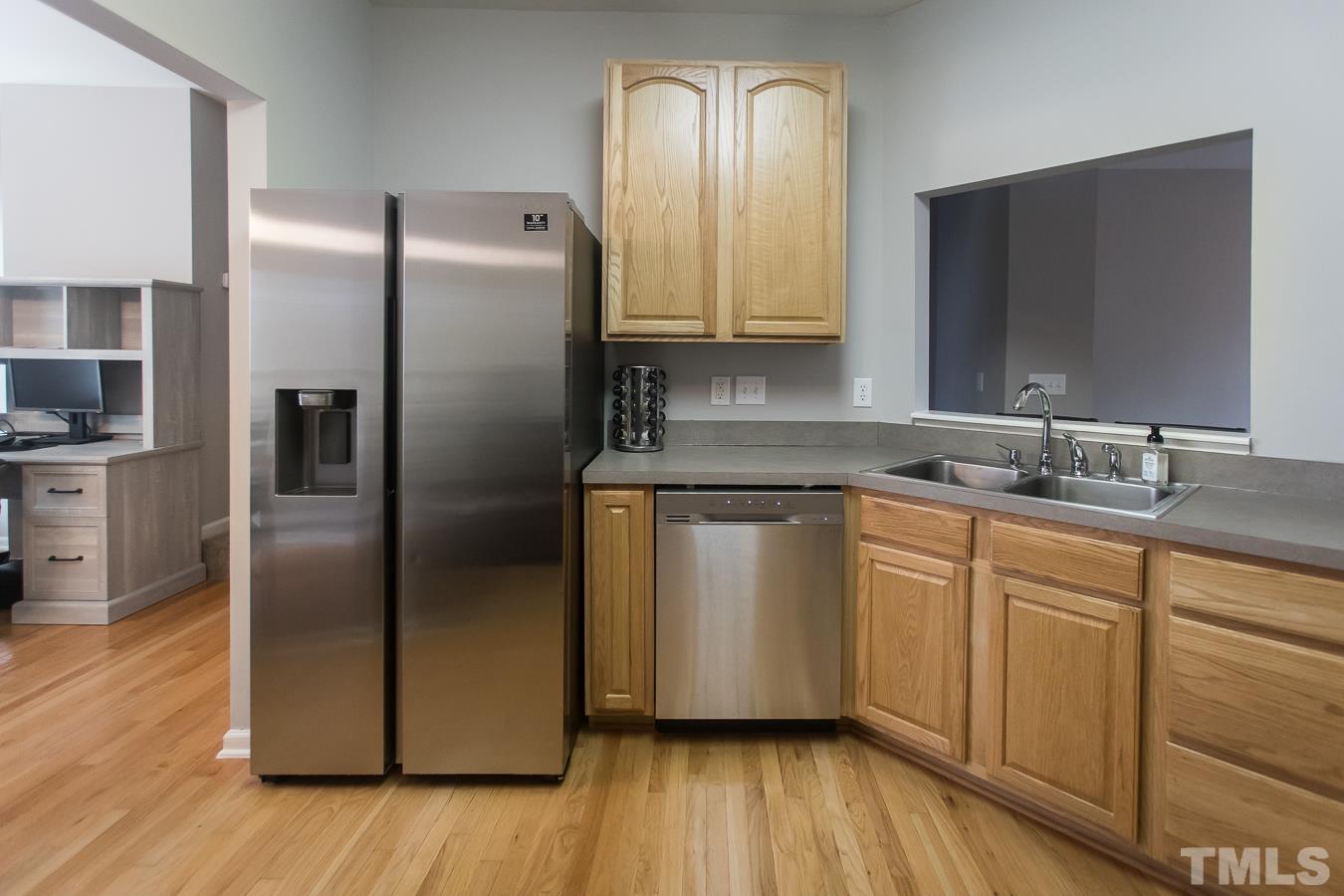 3137 Winding Waters Way Raleigh, NC 27614 - Photo 12 of 54 a kitchen with stainless steel appliances granite countertop a refrigerator a sink and wooden floor