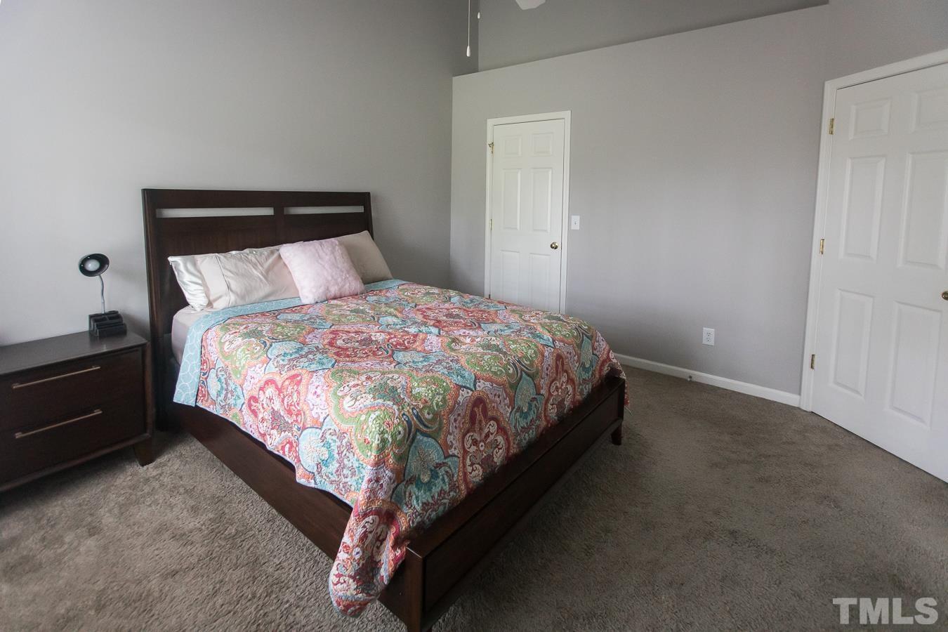 3137 Winding Waters Way Raleigh, NC 27614 - Photo 21 of 54 a large bed sitting in a bedroom next to a window