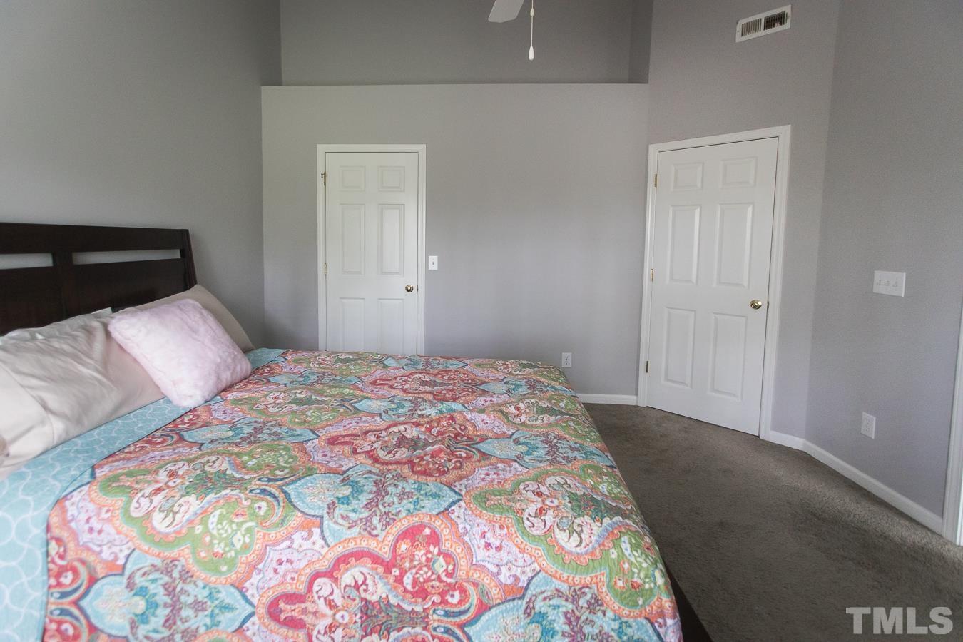 3137 Winding Waters Way Raleigh, NC 27614 - Photo 23 of 54 a bedroom with a bed and a lamp on dresser