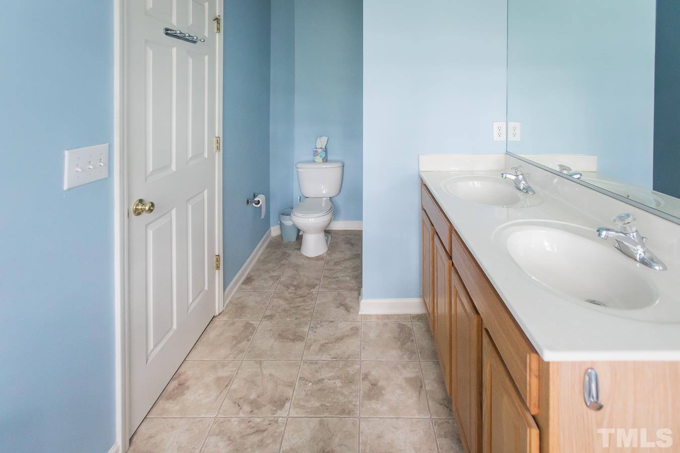 3137 Winding Waters Way Raleigh, NC 27614 - Photo 26 of 54 a bathroom with a sink a toilet and a mirror