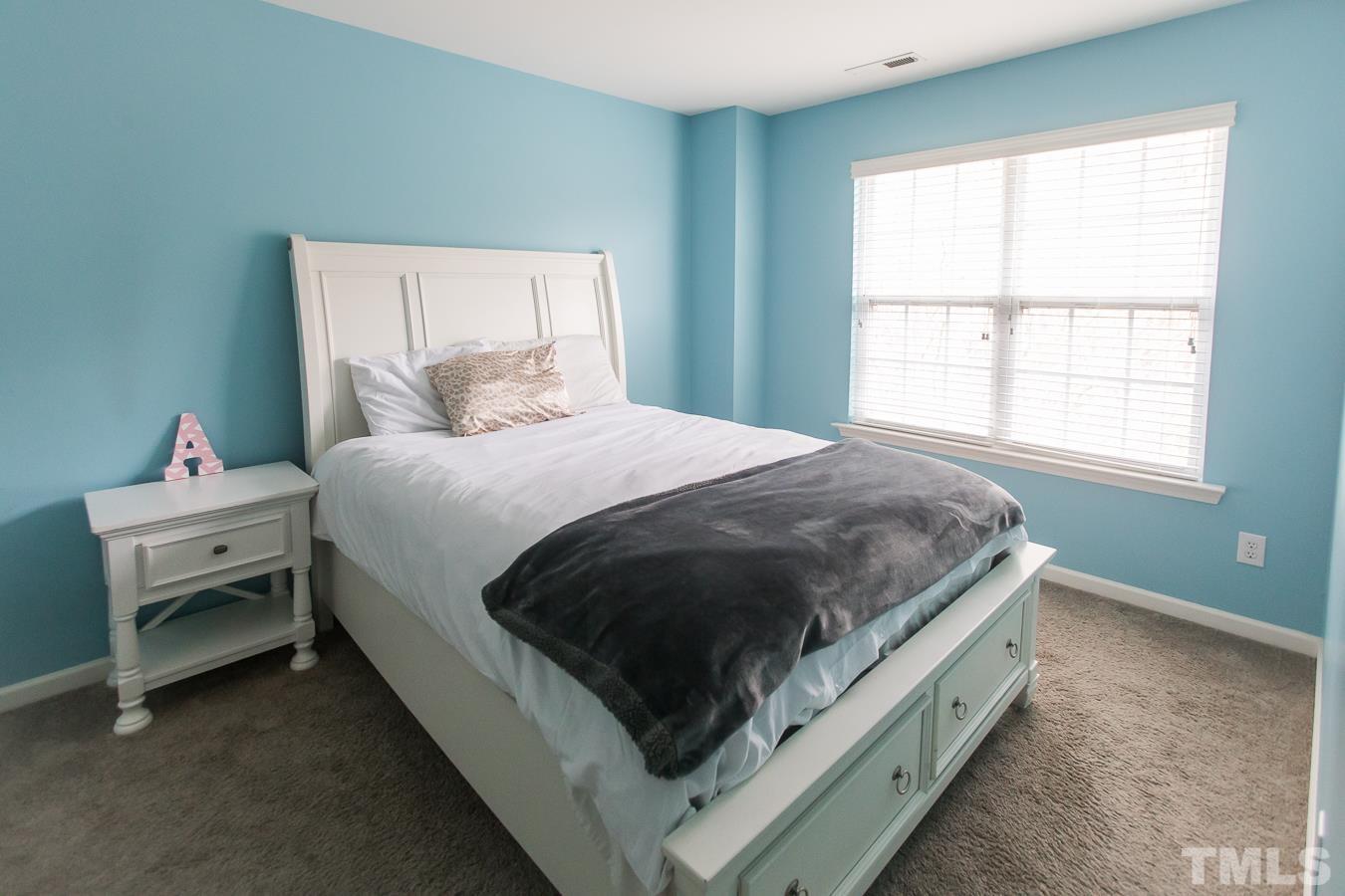 3137 Winding Waters Way Raleigh, NC 27614 - Photo 29 of 54 a spacious bedroom with a bed and a window