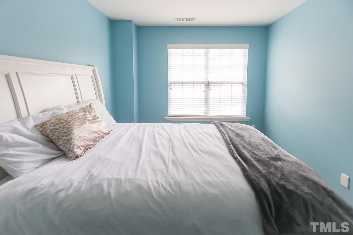 3137 Winding Waters Way Raleigh, NC 27614 - Photo 30 of 54 a bedroom with a bed and a window