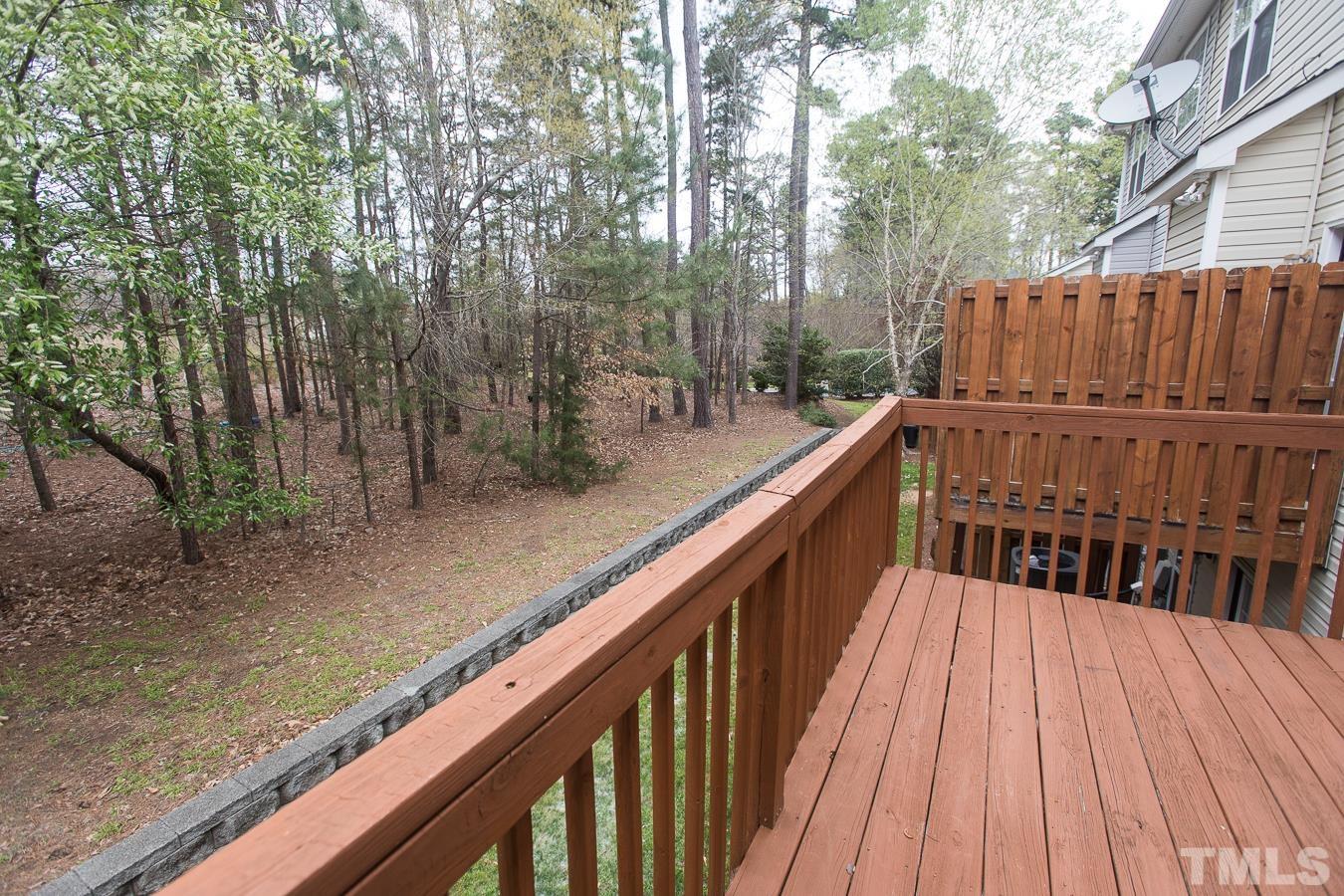 3137 Winding Waters Way Raleigh, NC 27614 - Photo 47 of 54 a balcony with wooden floor and trees in the back