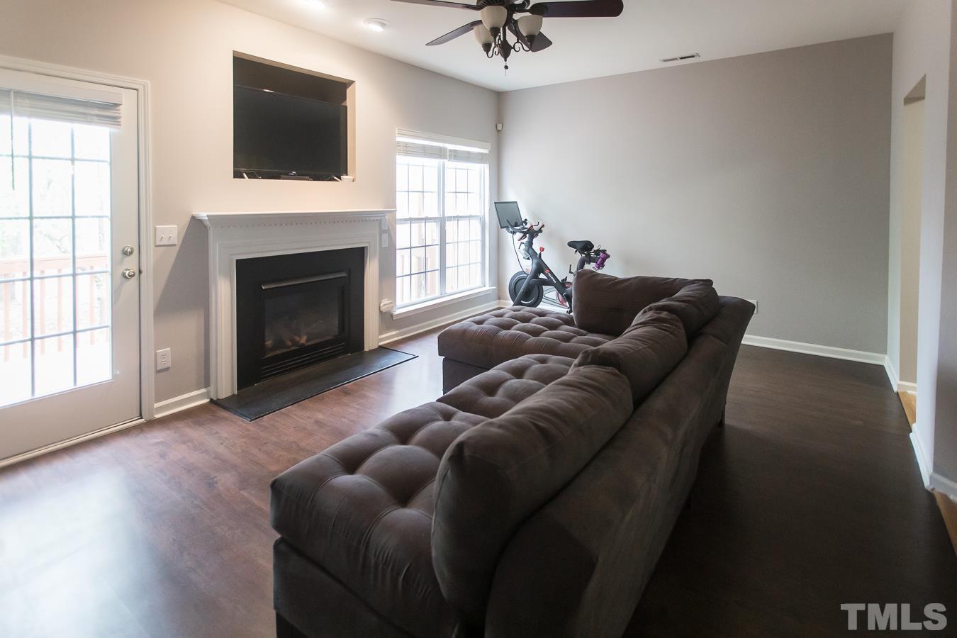 3137 Winding Waters Way Raleigh, NC 27614 - Photo 7 of 54 a living room with furniture and a fireplace