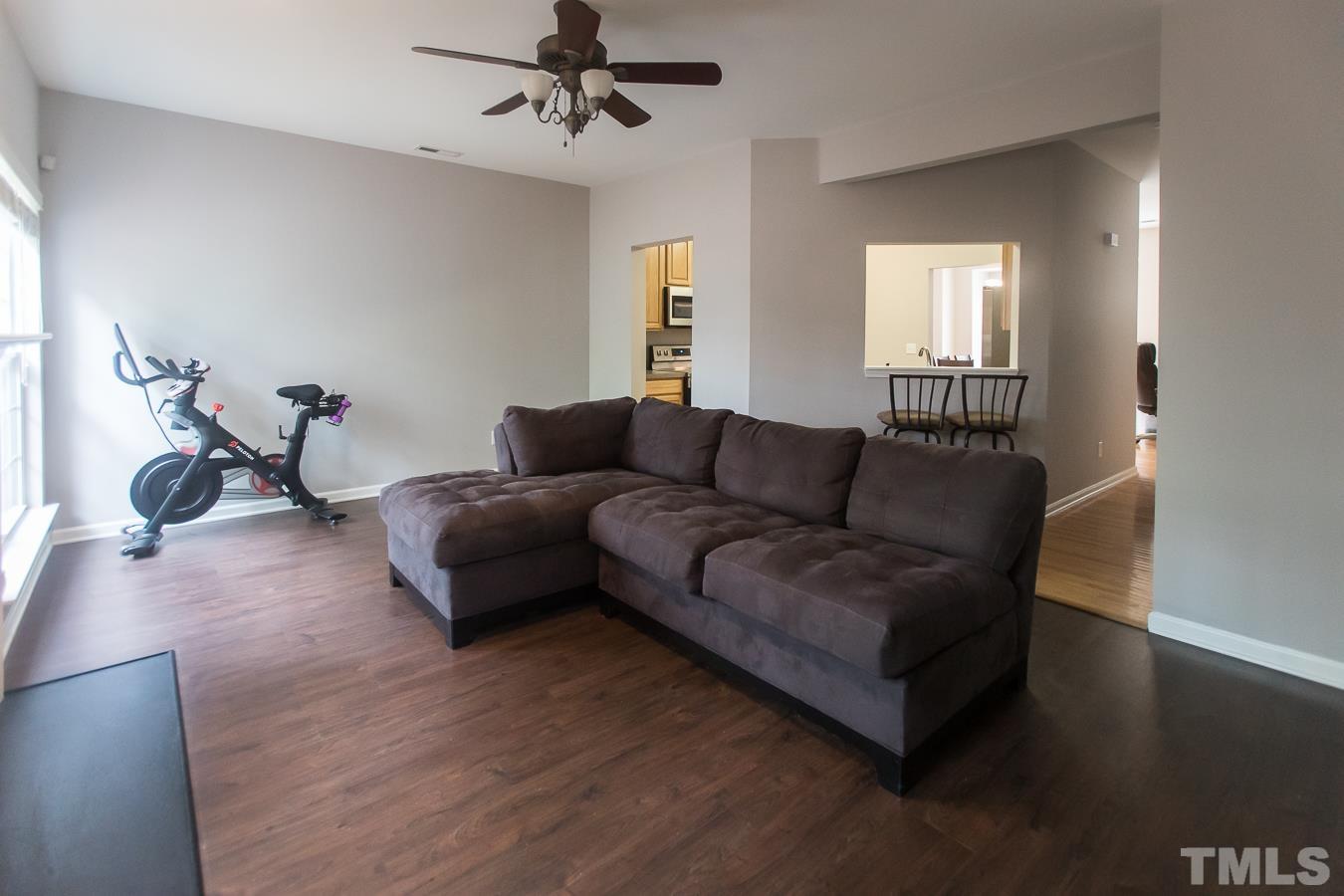 3137 Winding Waters Way Raleigh, NC 27614 - Photo 10 of 54 a living room with furniture a wooden floor and a window
