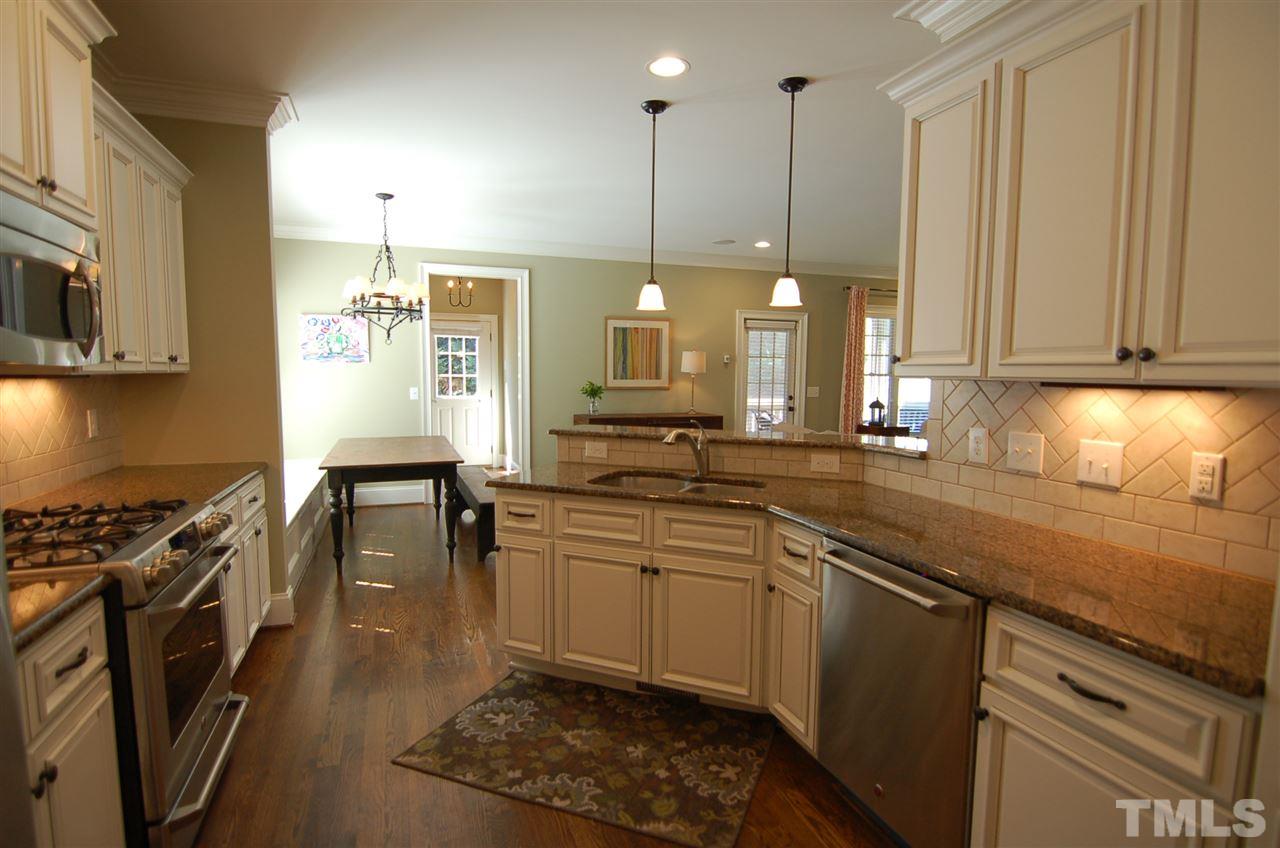 616 New Road Raleigh, NC 27608 - Photo 11 of 25 a kitchen with stainless steel appliances granite countertop a stove a sink and a refrigerator
