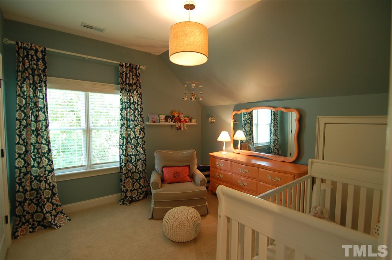 616 New Road Raleigh, NC 27608 - Photo 17 of 25 a room with furniture and a large window