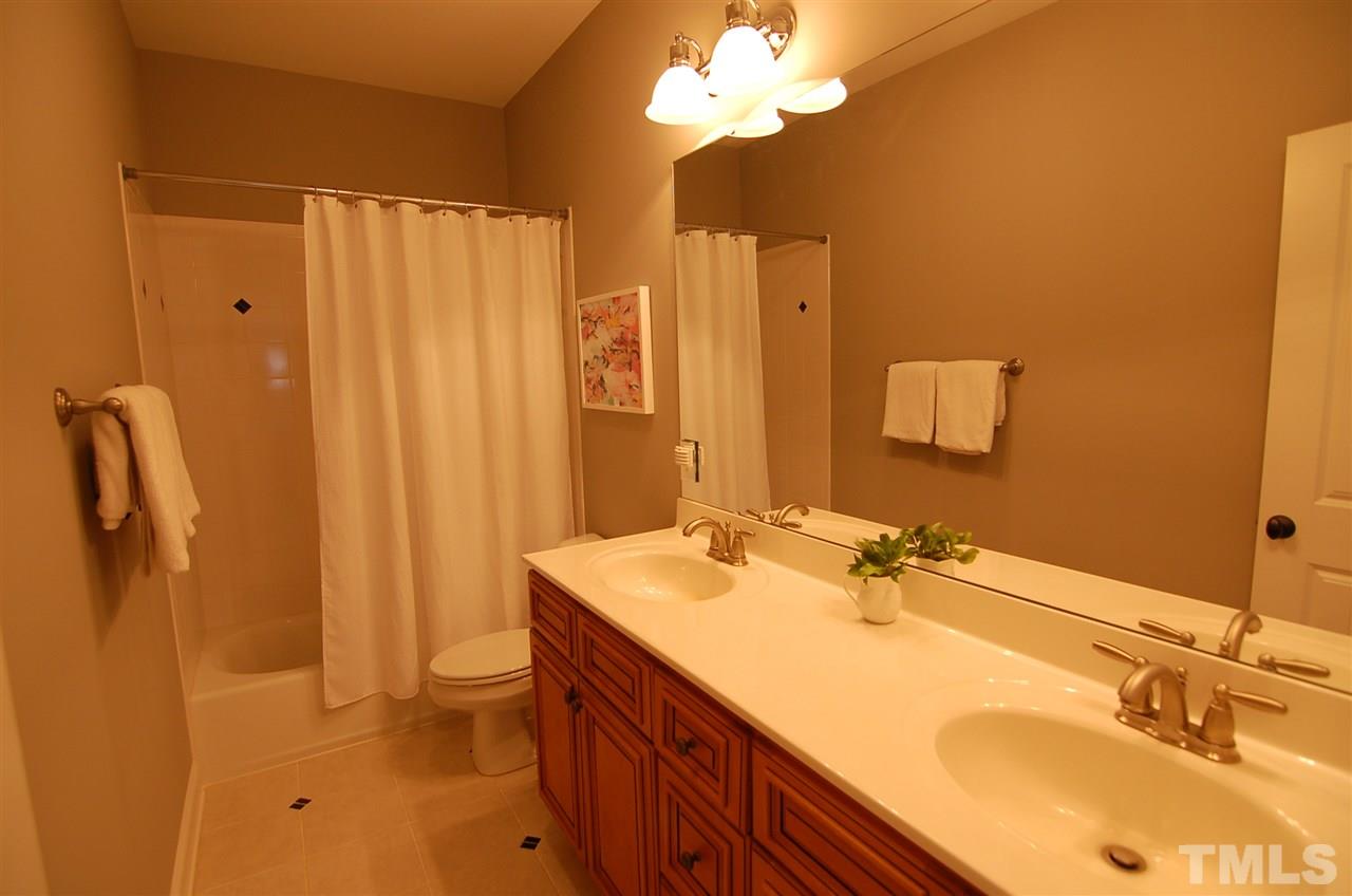 616 New Road Raleigh, NC 27608 - Photo 18 of 25 a bathroom with a granite countertop sink and a mirror