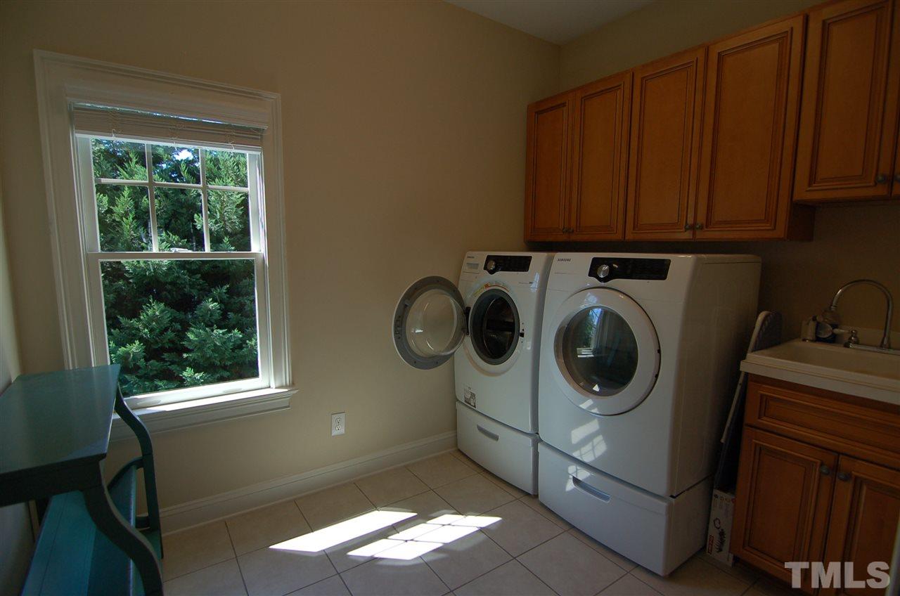616 New Road Raleigh, NC 27608 - Photo 21 of 25 a utility room with dryer and washer