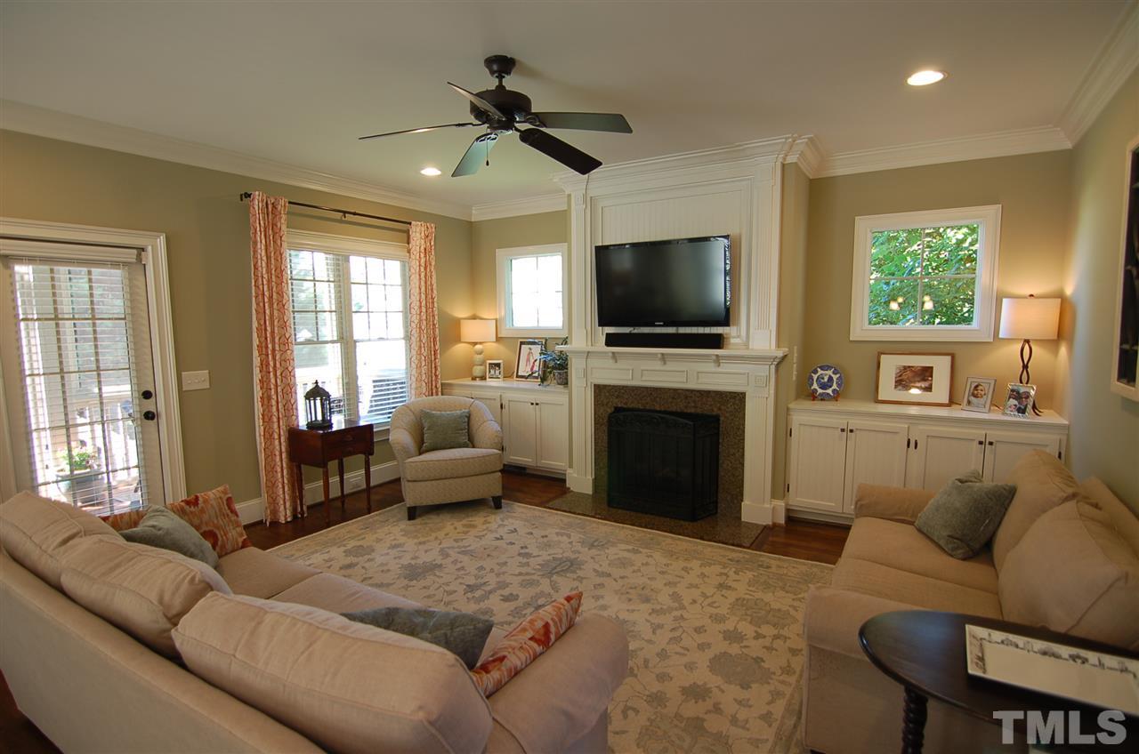 616 New Road Raleigh, NC 27608 - Photo 5 of 25 a living room with furniture a flat screen tv and a fireplace