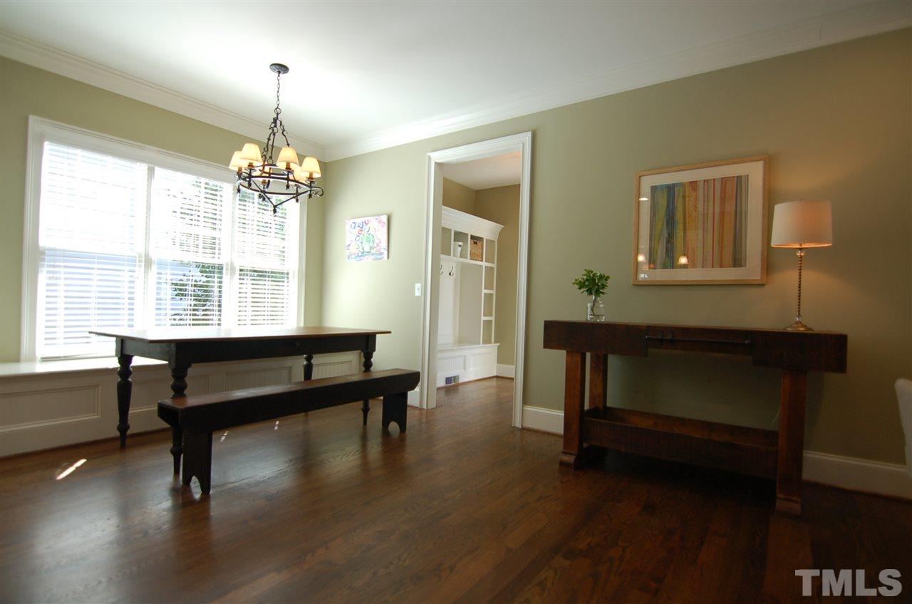 616 New Road Raleigh, NC 27608 - Photo 7 of 25 a room with table chairs and wooden floor