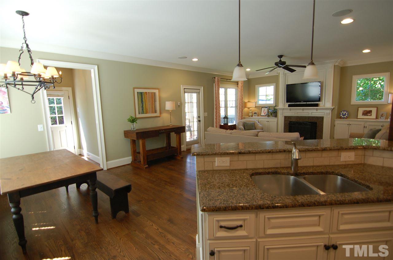 616 New Road Raleigh, NC 27608 - Photo 10 of 25 a kitchen with kitchen island granite countertop a sink a counter top space appliances and cabinets